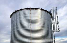 corrugated steel tank with a roof and ladder