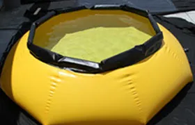 Inflatable yellow onion-shaped water tank with a protective black frame, used for temporary water storage.